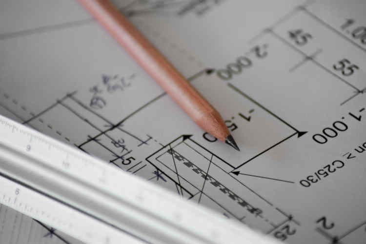New construction banner image with blueprints, pencil and scale - Platinum Builders